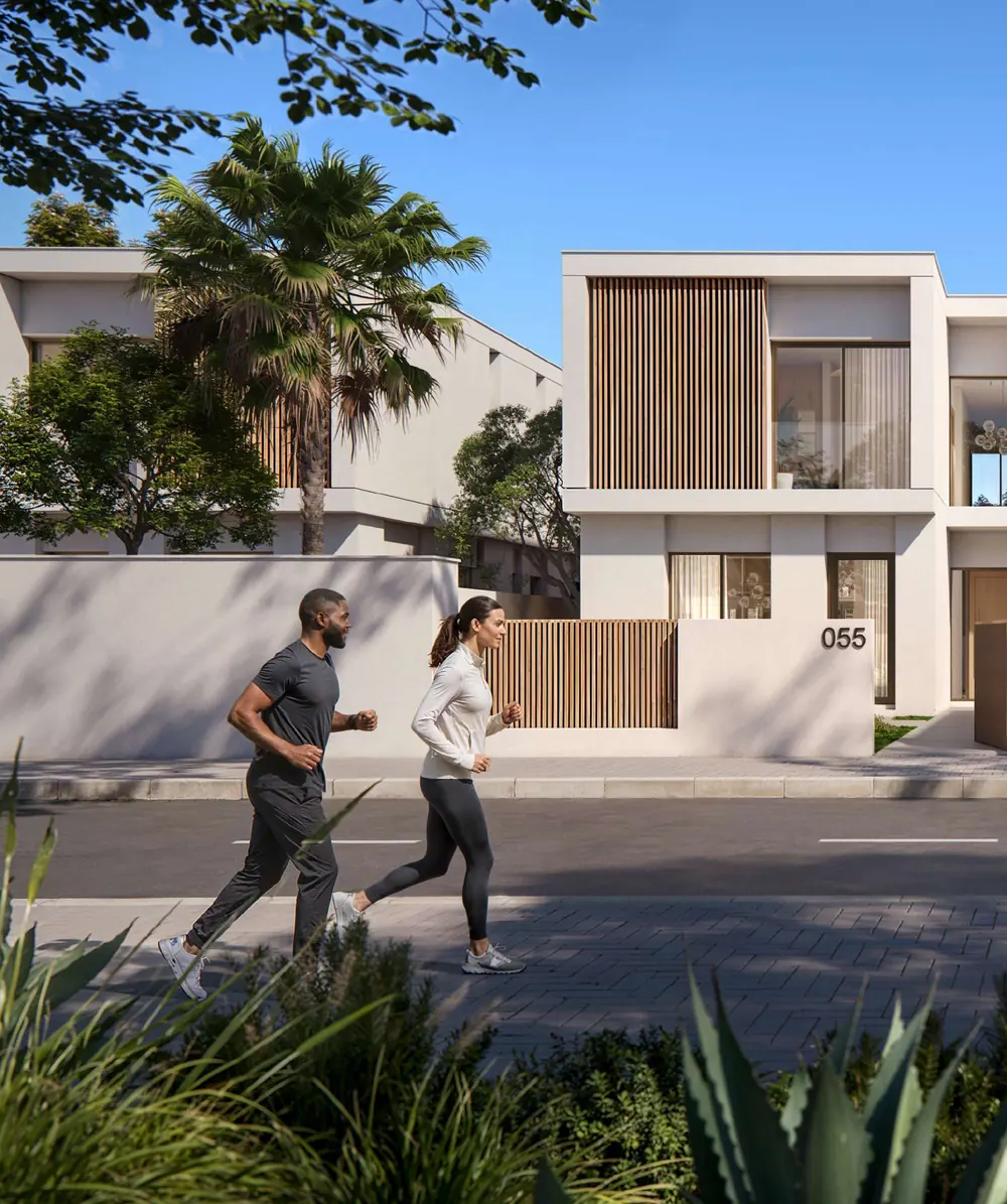 Residents jogging past a timber-screened villa